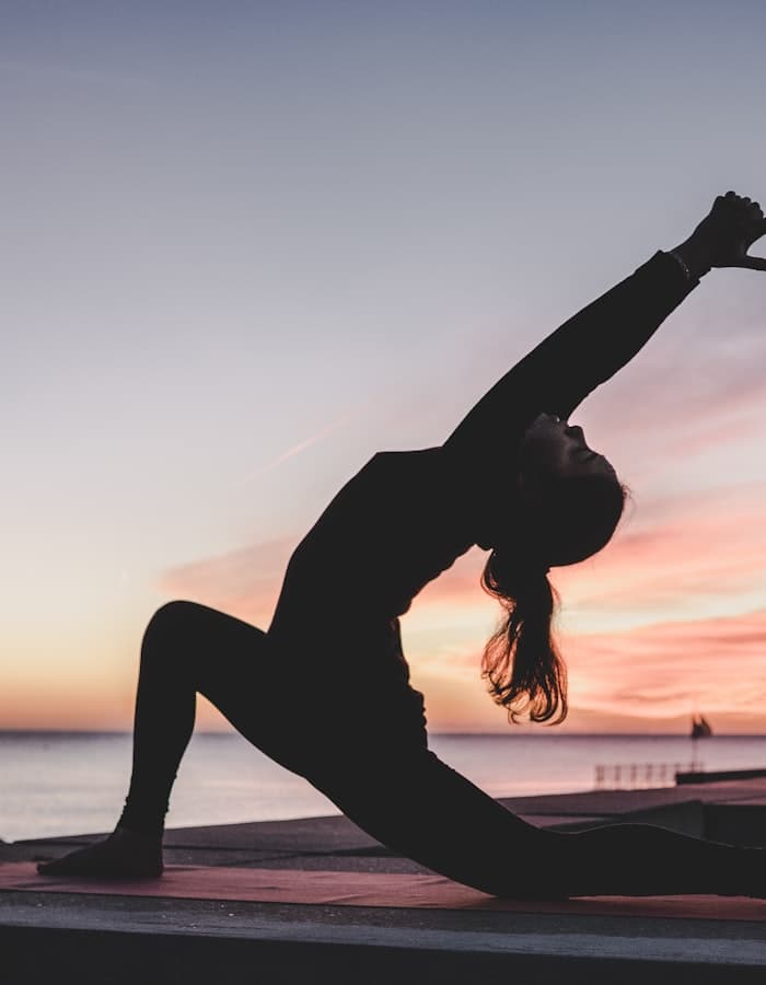 Group yoga class led by a coach
